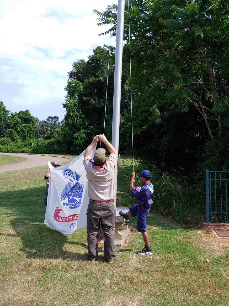 Picture of Scouts raising the Army flag as the first service flag